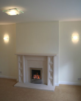 Limestone feature fireplace against the dummy chimney breast